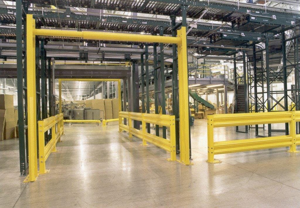 four men in hardhats working in industrial shipping warehouse organized with stainless steel platforms, stairways, and guard rail posts