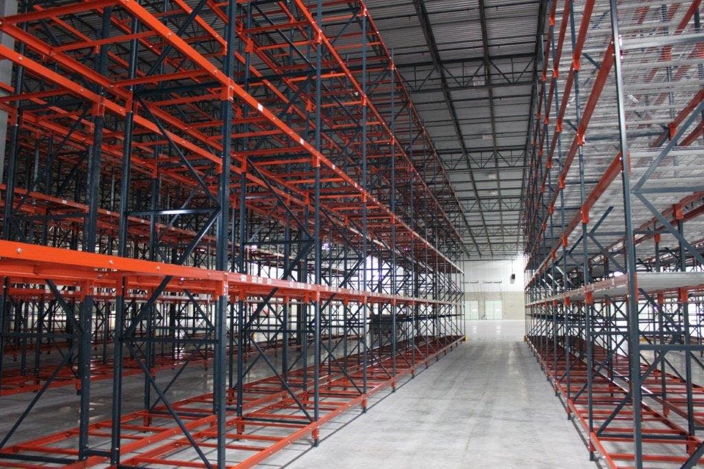 red structural steel selective racks utilizing high ceilings in shipping warehouse card